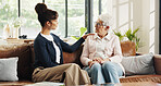 Conversation, volunteer and senior woman in house for rehabilitation, checkup and post surgery recovery. Apartment, pensioner or elderly person in living room for support, chat and advice for help