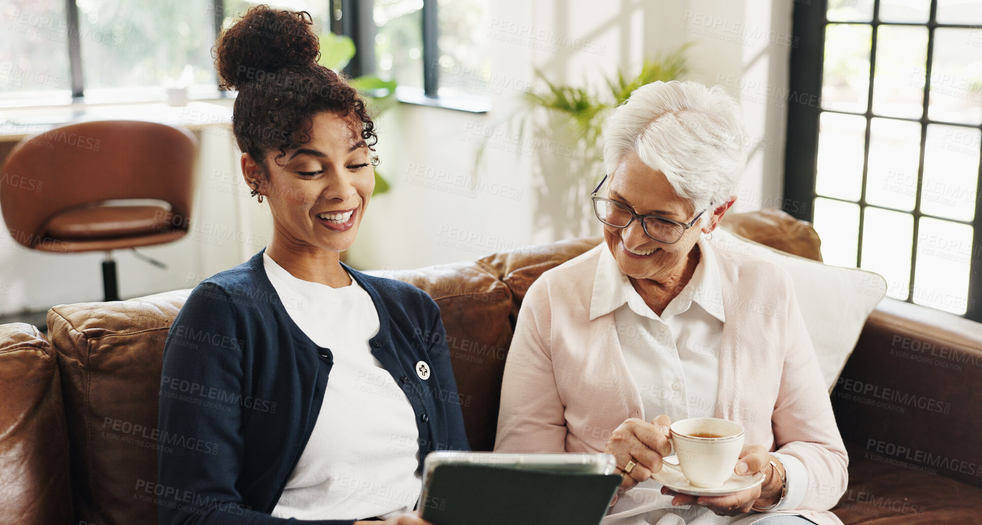 Buy stock photo Old woman, nurse and tablet on couch with smile for streaming, video or article in living room. People, caregiver and elderly person with tech, app and happy with drink on sofa in retirement at house