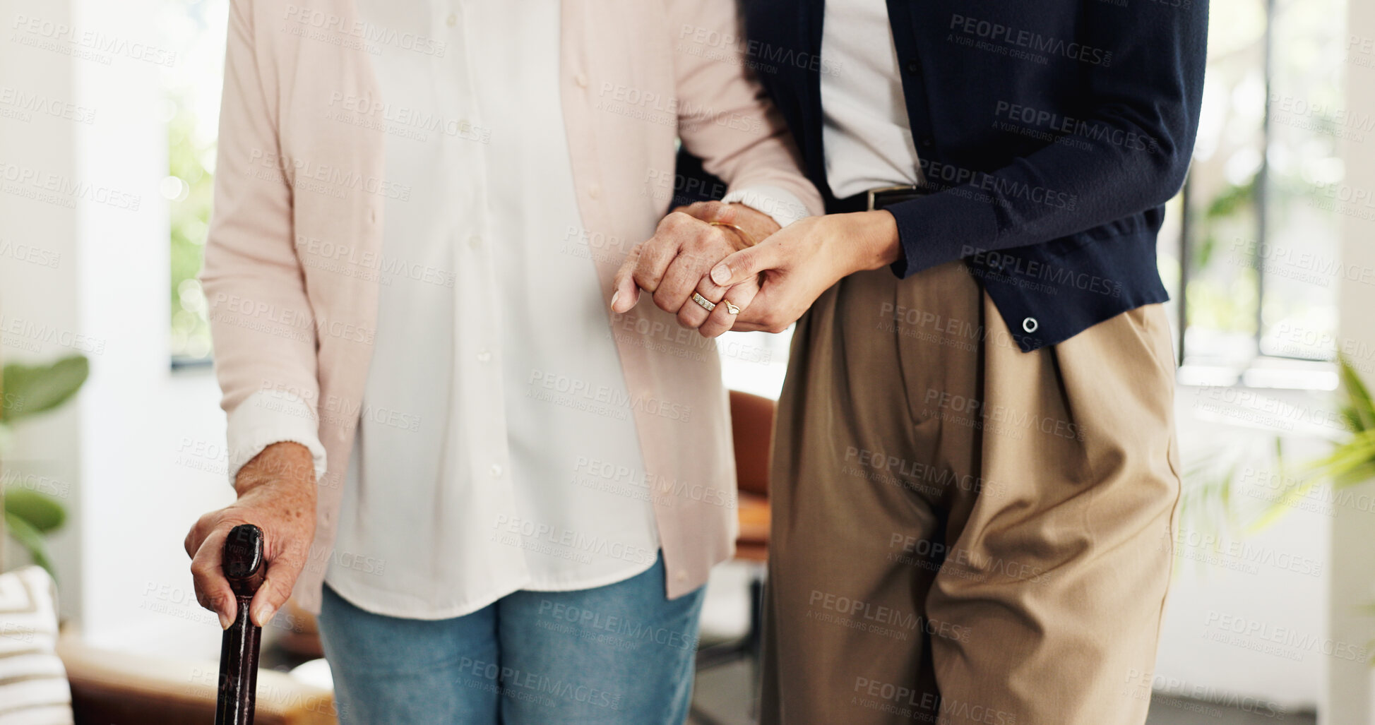 Buy stock photo Nurse, patient and holding hands with cane in home for mobility, help or balance in retirement. People, caregiver and senior person with disability, walking stick or steps for rehabilitation at house