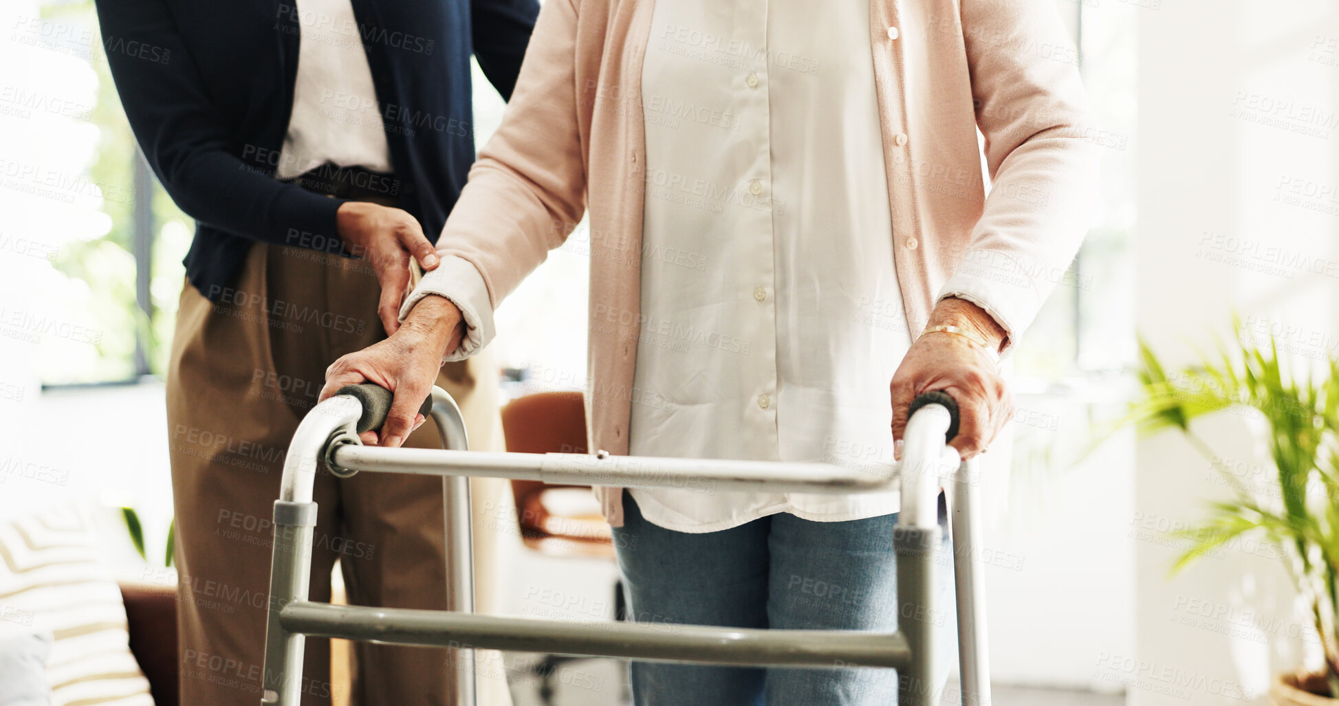 Buy stock photo Hands, nurse and patient with walker in home for mobility, balance or support in retirement. People, caregiver and elderly person with disability, walking frame or rehabilitation for healing at house