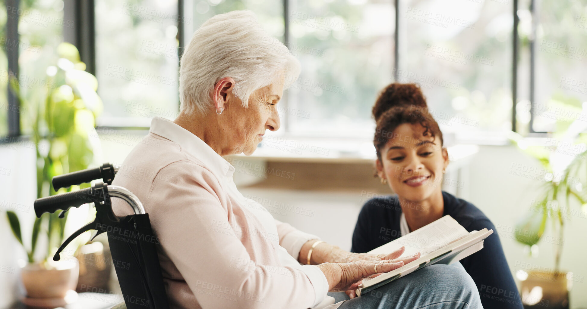 Buy stock photo Old woman, nurse and reading book with wheelchair in home with smile, support or recovery for injury. People, caregiver and elderly patient with disability, rehabilitation or literature in retirement