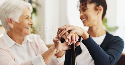 Buy stock photo Holding hands, patient and nurse on sofa in home with support, healing and cane with injury in retirement. Elderly woman with disability, caregiver and walking stick for rehabilitation in house