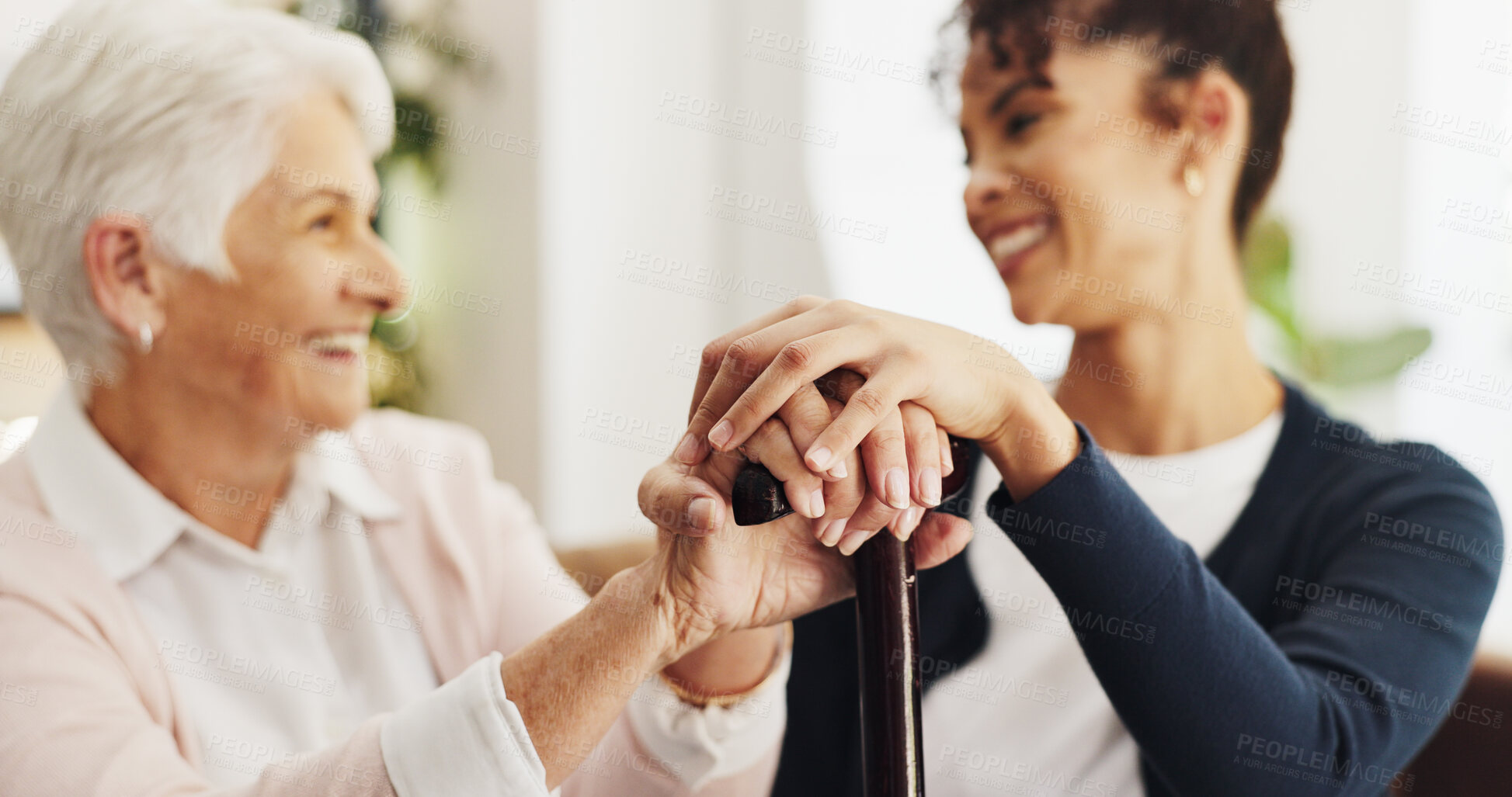 Buy stock photo Holding hands, patient and nurse on sofa in home with support, healing and cane with injury in retirement. Elderly woman with disability, caregiver and walking stick for rehabilitation in house