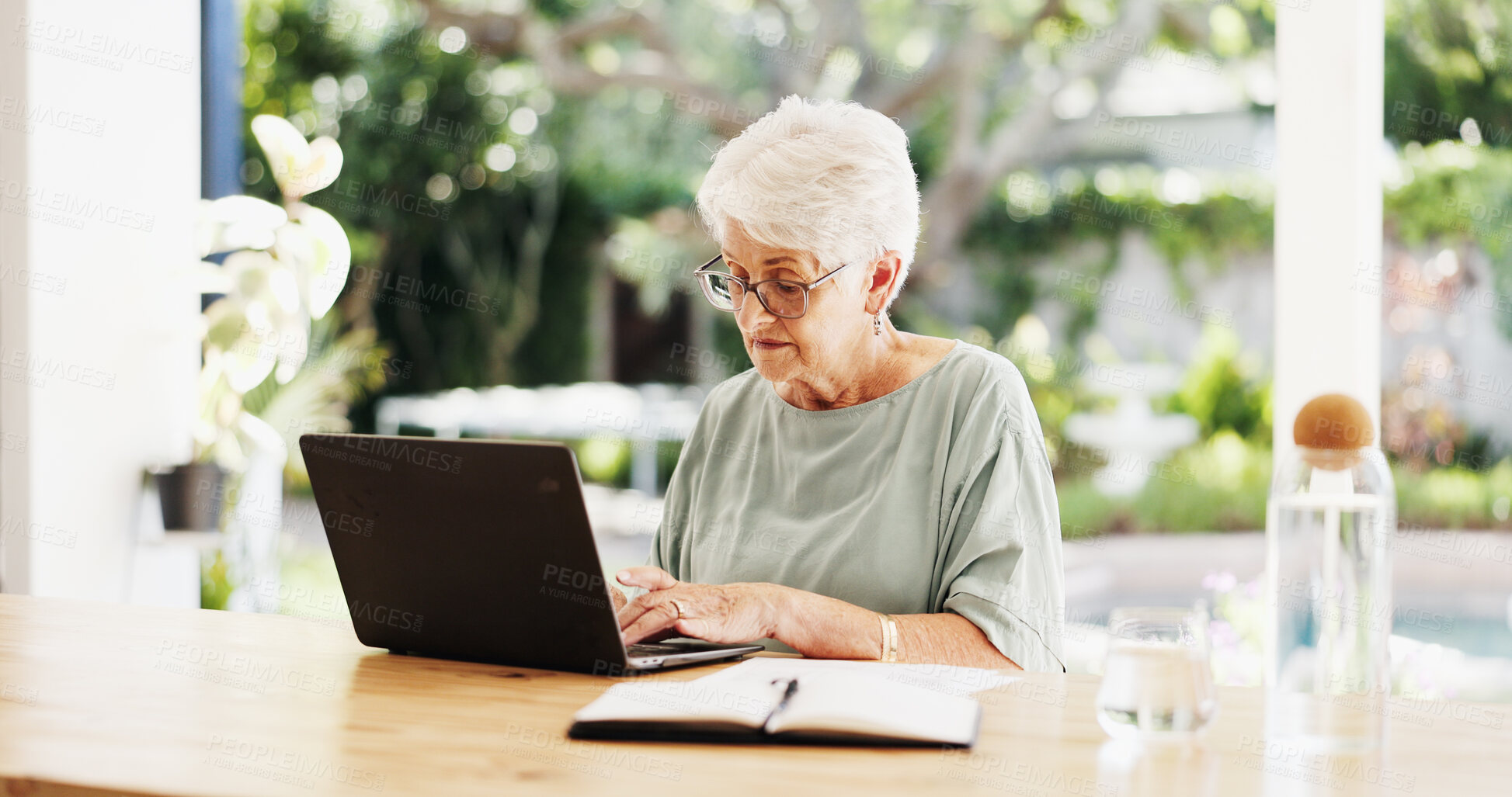 Buy stock photo Reading, laptop and senior woman in lounge, planning for retirement policy and investment portfolio. Finance review, pensioner or old person in home, pc or email for insurance benefits or internet