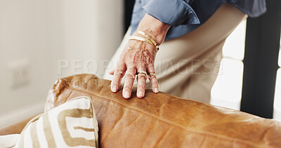 Buy stock photo Sofa, fabric and hand of senior woman in home with feeling leather on weekend in living room. Jewelry, retirement and elderly female person touching texture of couch for interior design in house.