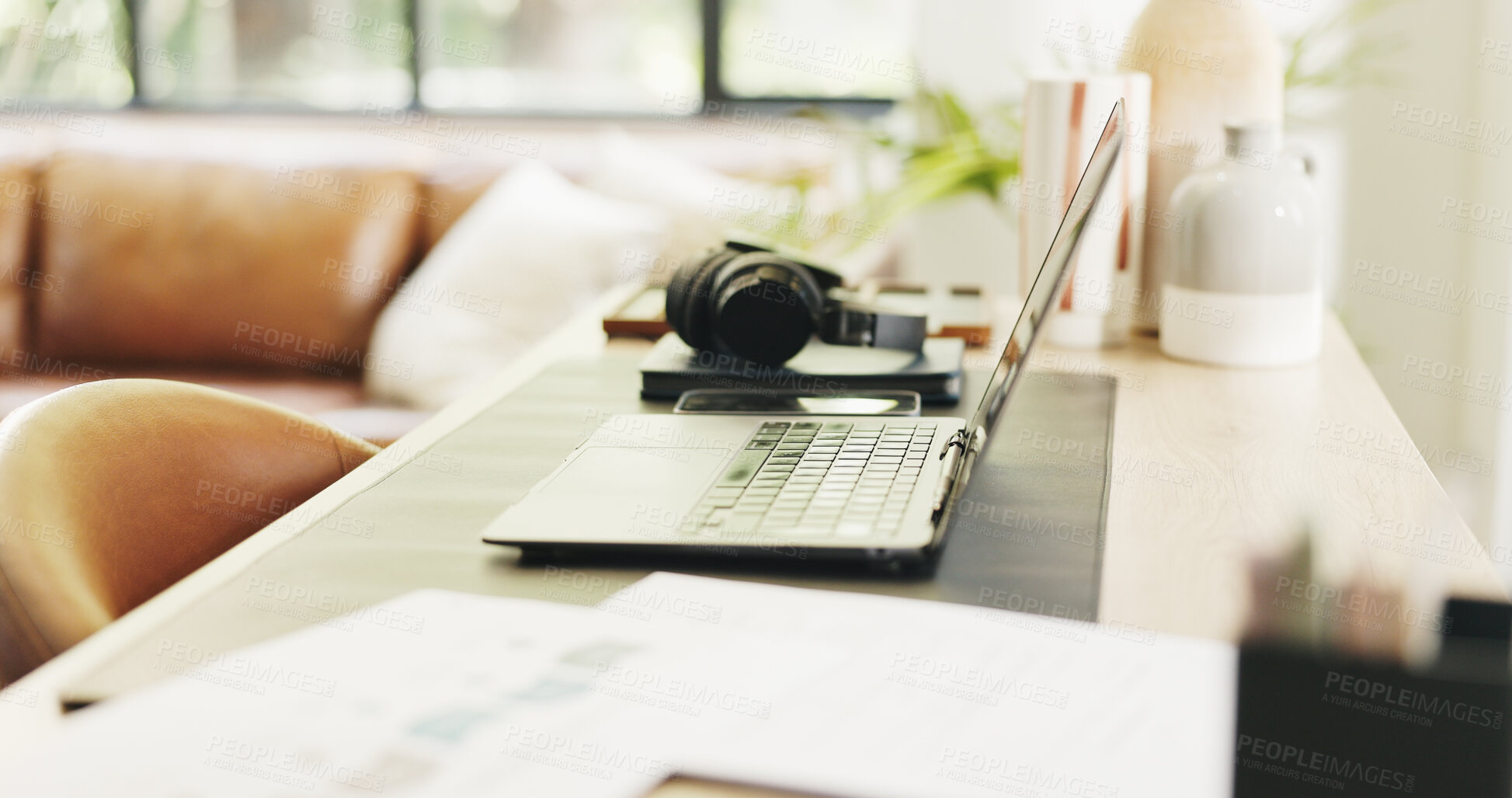 Buy stock photo Headphones, laptop and remote work setup in home office for research, planning and document. Creative workspace, technology and paperwork for online, freelance or small business in house lounge