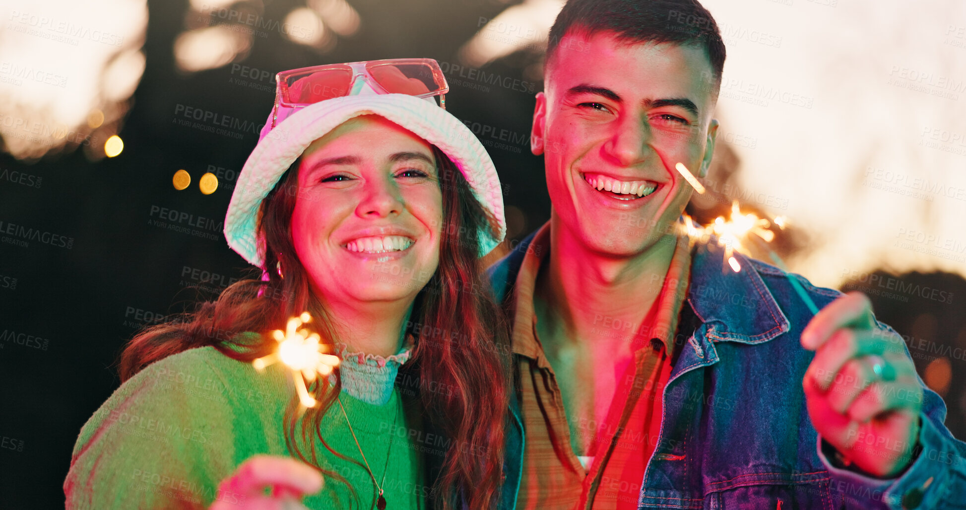 Buy stock photo Portrait, couple and laugh with sparkler outdoor for fun weekend, celebration and festival event. Happy, people or fireworks for rave culture, social gathering and bonding together at new years party