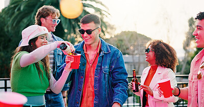 Buy stock photo Outdoor, party and friends pour drinks on balcony, bonding and social gathering for weekend celebration. Hang out, reunion event and people with alcohol beverage for fun, summer festival and smile