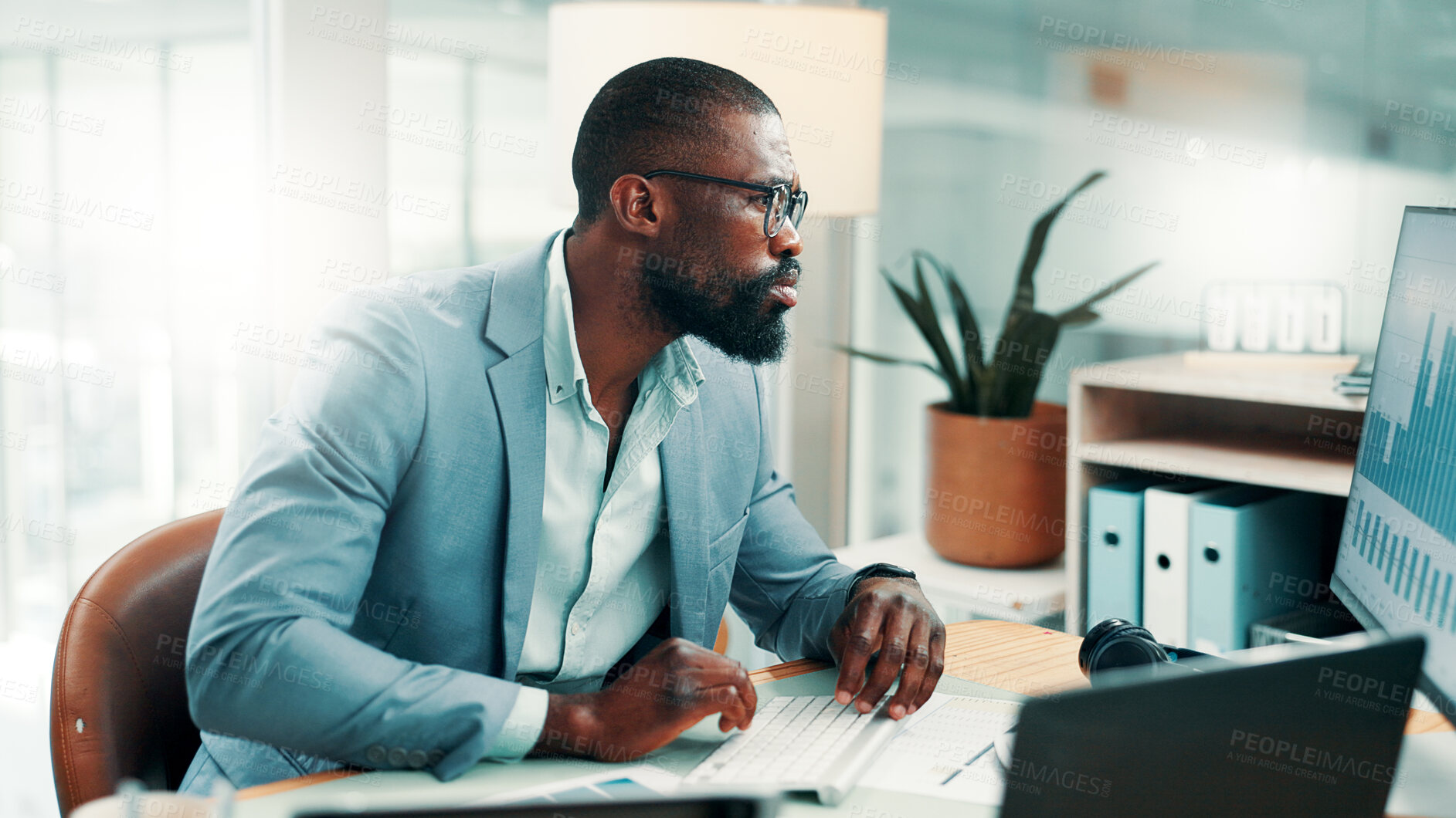 Buy stock photo Black man, typing and computer with graphs at office for review, insight and glasses at investment company. Person, broker or financial advisor with pc for charts, statistics and flare at agency