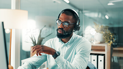 Buy stock photo Call center, computer and black man in office, reading for system policy and glasses. African person, consultant and employee in workplace, headset and pc for customer support, eyewear and connection