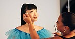 Makeup artist, photography and preparation with model in studio for behind the scenes styling. Blush brush, cosmetics and getting ready with women on set of photoshoot for film or media production
