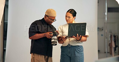 Buy stock photo Creative, people and photographer in studio with laptop, camera and partnership for media project. Photography, team and collaboration on set with film production, computer and discussion for idea.