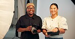 Portrait, photographer and people in studio with camera, clipboard or partnership for creative project. Happy, photography team or collaboration on set with film production, equipment or media agency
