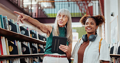 Buy stock photo Women, student and help at library with search for books with tablet, point and happy at college campus. People, librarian and girl with tech, application or scholarship with education at university