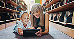 Child, tablet and mature woman in library with smile, reading ebook and literature for development. Happy, grandmother and girl with tech for storytelling kids app, knowledge and bonding together.
