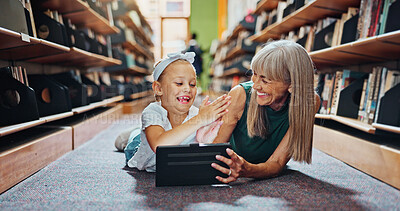 Buy stock photo High five, library and tablet with student and teacher on floor together for learning or reading. Celebration, education and success with woman teaching excited girl child in school for growth