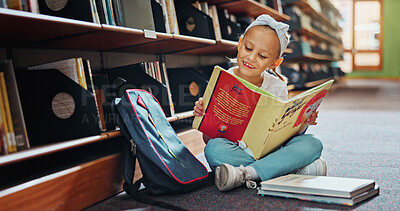 Buy stock photo Reading, smile and child with book in library, language skills and vocabulary development for education. Literacy knowledge, fantasy story and girl with literature to learn,  academic growth and info