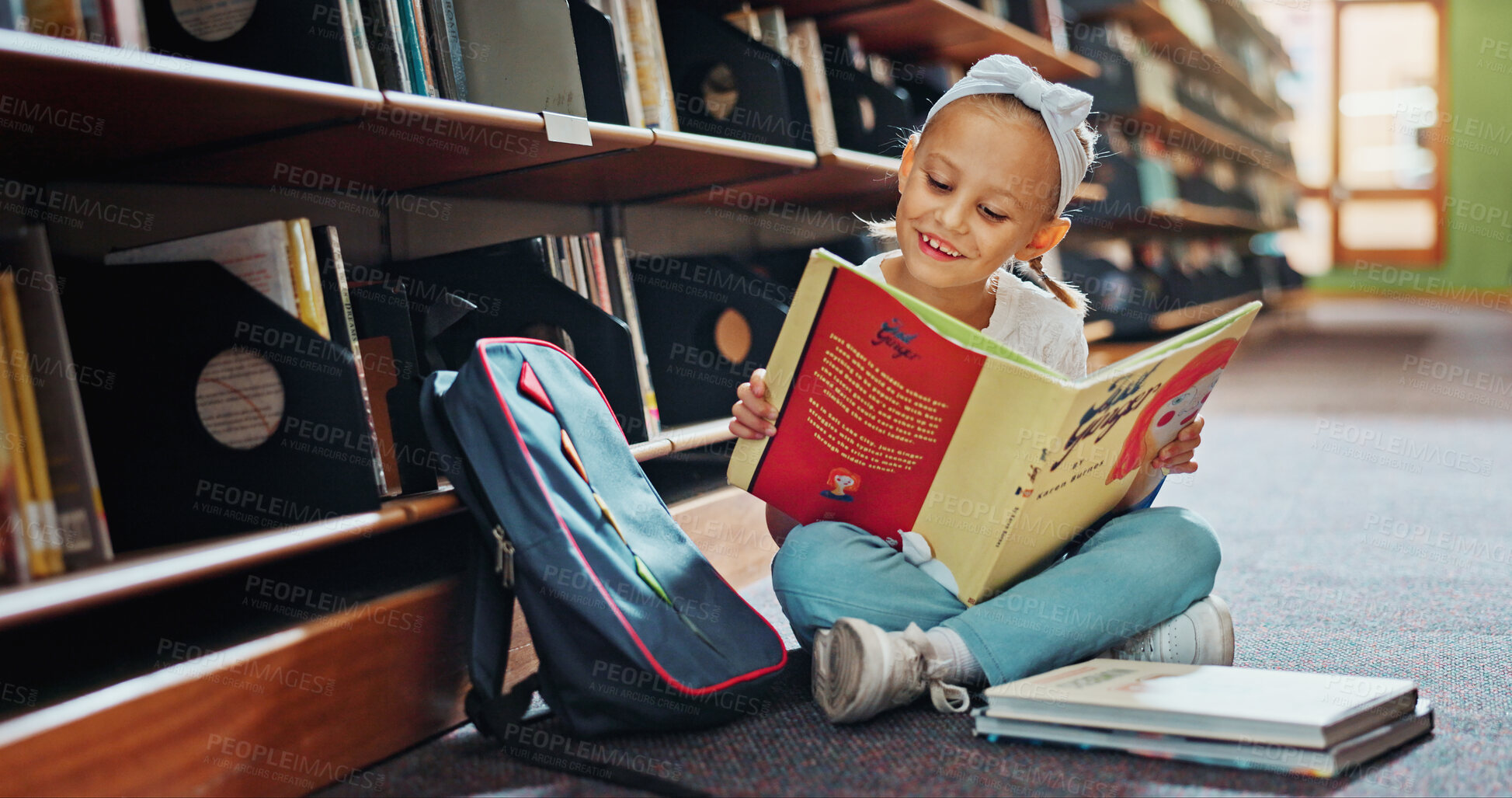 Buy stock photo Reading, smile and child with book in library, language skills and vocabulary development for education. Literacy knowledge, fantasy story and girl with literature to learn,  academic growth and info