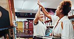 Happy women, students and high five with book in library for studying course or lesson together. Female people, learners or friends with smile or textbooks for school project, winning or research