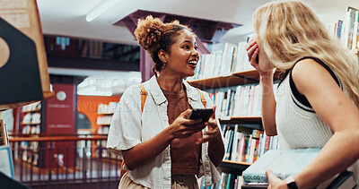 Buy stock photo Excited, friends and women with smartphone, library and shock for exam results, good news and online. College students, surprise and people with mobile for positive feedback, happiness and education