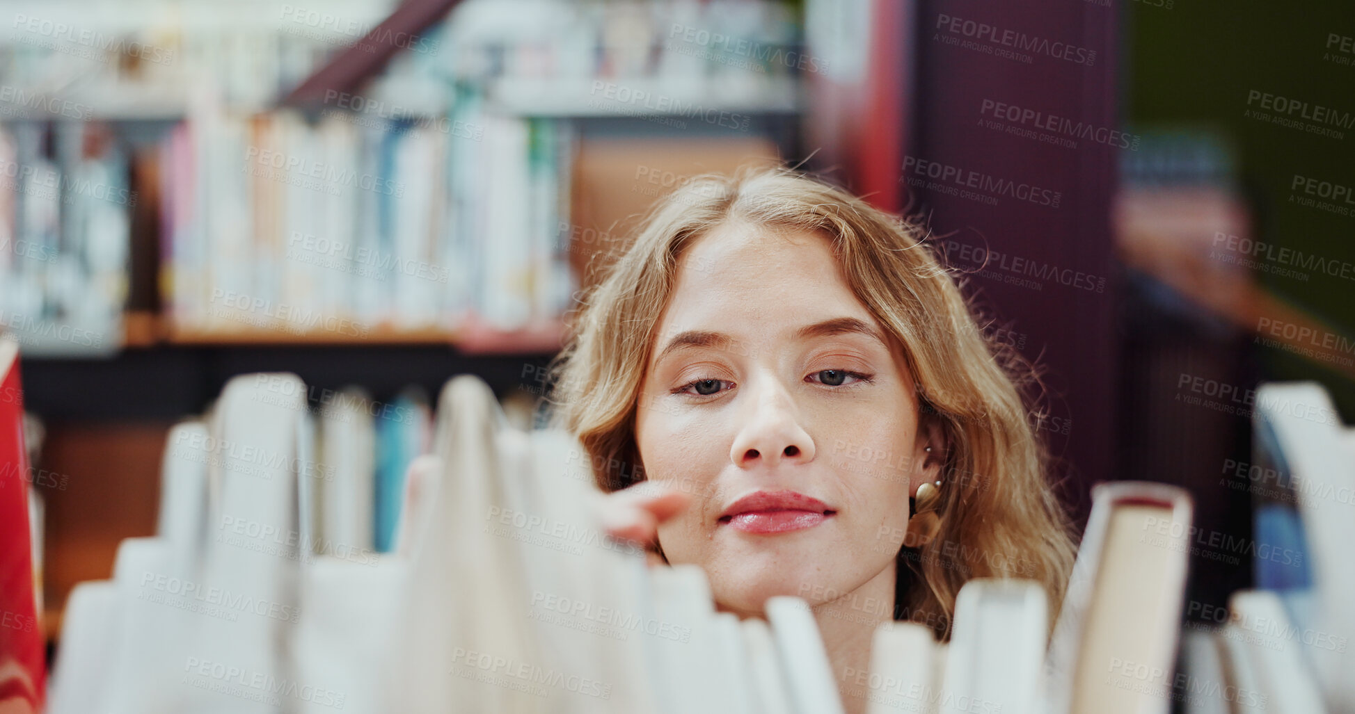 Buy stock photo Student, girl and search on bookshelf at college for book choice, pick textbook and knowledge. University, person and check course resources in library for study research, thesis citation or learning