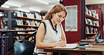Happy woman, student or writing with book for education, knowledge or learning in school library. Female person, studying or taking notes with diary for project research or assessment on campus