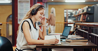 Buy stock photo Headphones, laptop or college student writing in library, course notes or streaming music for studying. Smile, tech or woman with notebook to learn, educational podcast or research for knowledge test