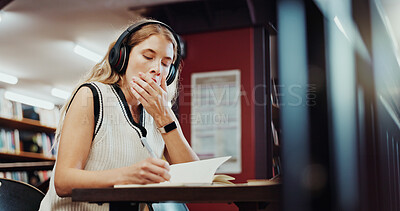 Buy stock photo Headphones, yawn or university student writing in library, study notes or streaming music for fatigue. Knowledge, tech or tired woman with notebook to learn, educational podcast or exam preparation