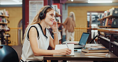 Buy stock photo Student, woman and writing in library with headphones, laptop and music playlist for studying english. Person, thinking and audio tech at university with literature notes, reflection or online radio.