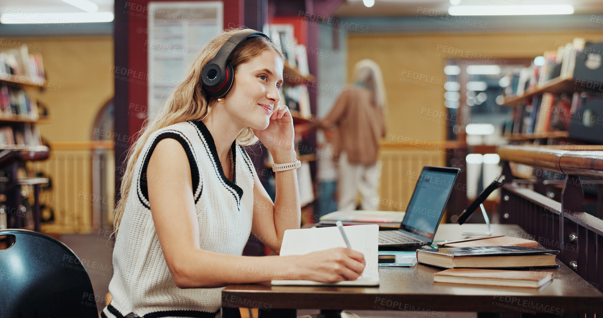 Buy stock photo Student, woman and writing in library with headphones, laptop and music playlist for studying english. Person, thinking and audio tech at university with literature notes, reflection or online radio.