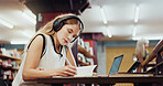 College, woman and writing in library with headphones, study and music playlist for english assignment. Student, person and audio tech at university with literature notes, knowledge and online radio.