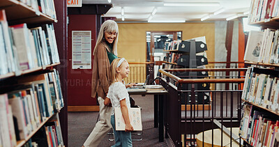 Buy stock photo Child, grandma and walk in library with book, knowledge support or bonding together for development. Happy, senior woman and girl in bookshop for education, english literature or guidance for growth.