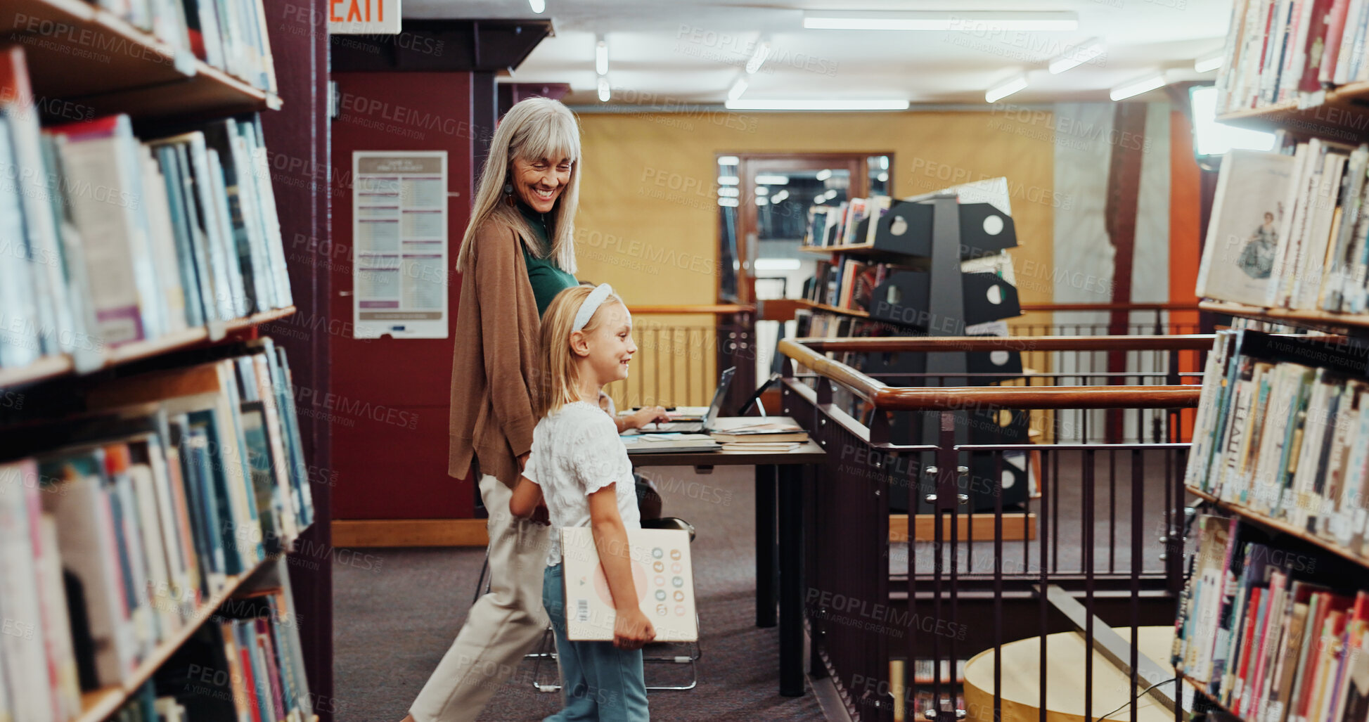 Buy stock photo Child, grandma and walk in library with book, knowledge support or bonding together for development. Happy, senior woman and girl in bookshop for education, english literature or guidance for growth.