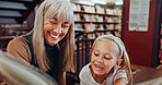 Grandma, girl and reading book in library with smile, education or knowledge support for development. Family, senior woman and grandchild in bookshop for novel, storytelling or literature for growth.