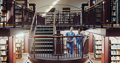 Buy stock photo Nurse, education and women in library, research for anatomy project and university scholarship. Uniform, medical students and people with books, staircase and knowledge for development and discussion