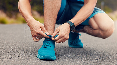 Buy stock photo Man, hands and tie with shoes on road for fitness, workout preparation or outdoor exercise. Active, male person or runner getting ready with sneakers or tying for cardio training on asphalt or street
