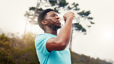 Buy stock photo Black man, fitness and drinking water in nature for hydration, rest or workout recovery. Active, male person or runner with mineral liquid or beverage for break, exercise or outdoor training