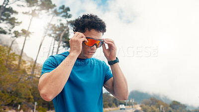 Buy stock photo Fitness, outdoor and man with sunglasses for uv protection, wellness and challenge. Nature, athlete and person with shield eyewear, polarized lenses or workout for health benefits, exercise or safety