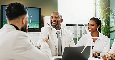 Buy stock photo Man, handshake and happy at office meeting with windmill model, success and deal for sustainable business. People, team and excited with eco friendly electricity, goal and renewable energy at agency