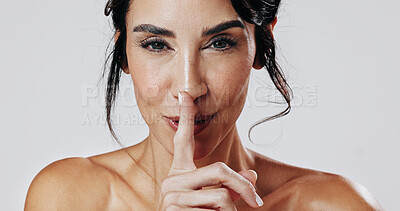 Buy stock photo Beauty, hush and portrait of woman in studio for cosmetics or dermatology benefits and secrets. Finger on lips, mature and skincare with model isolated on white background for mystery or privacy