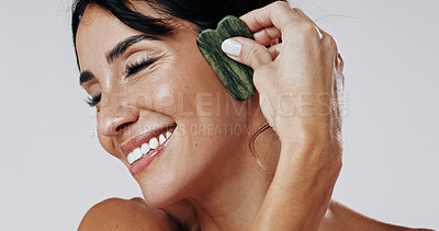 Buy stock photo Woman, gua sha and happy with skincare in studio for circulation, massage and glow on white background. Mature person, stone tools and cosmetics with benefits, lymphatic drainage and dermatology
