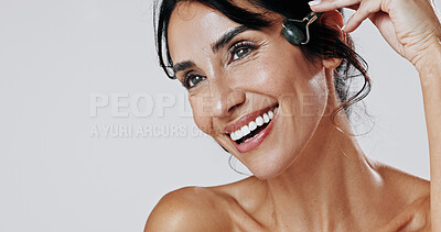 Buy stock photo Happy woman, beauty and skincare with jade roller in studio for anti aging on a white background. Female person, model or blood circulation with quartz tool for lymphatic drainage treatment on space