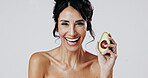 Happy woman, avocado and skincare in studio portrait with glow, wellness and space on white background. Mature person, smile and fruit for natural cosmetics, dermatology and benefits in Argentina