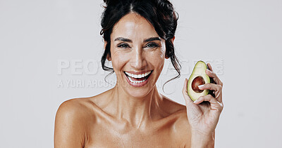 Buy stock photo Happy woman, avocado and skincare in studio portrait with glow, wellness and space on white background. Mature person, smile and fruit for natural cosmetics, dermatology and benefits in Argentina