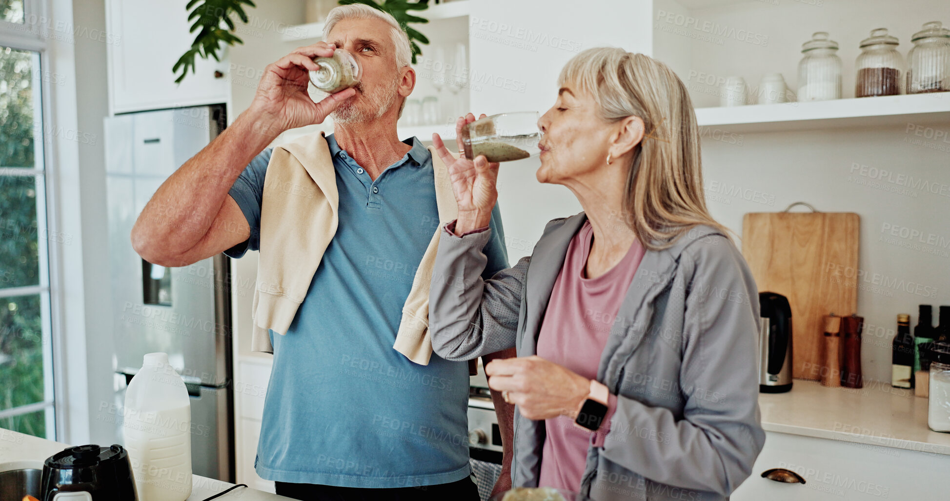 Buy stock photo Exercise, drinking smoothie and old couple in kitchen for nutrition, breakfast and supplements. Fitness, mature man and woman in home, health and protein shake for wellness, diet plan and minerals