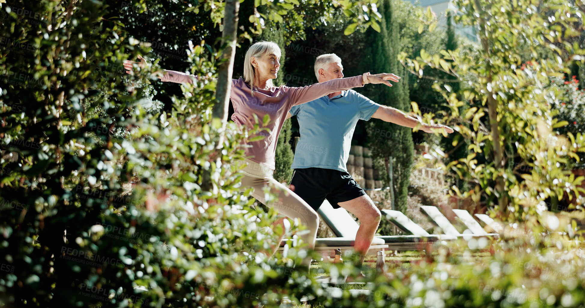 Buy stock photo Yoga, stretching and elderly couple in backyard, holistic exercise and morning routine for body wellness. Active, chakra and senior people with warrior pose in garden, balance and retirement fitness