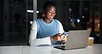 Night, laptop and black woman in office with phone, journalist research and text message for story. Late, person and typing in workplace with tech, computer and check email for feedback on article.