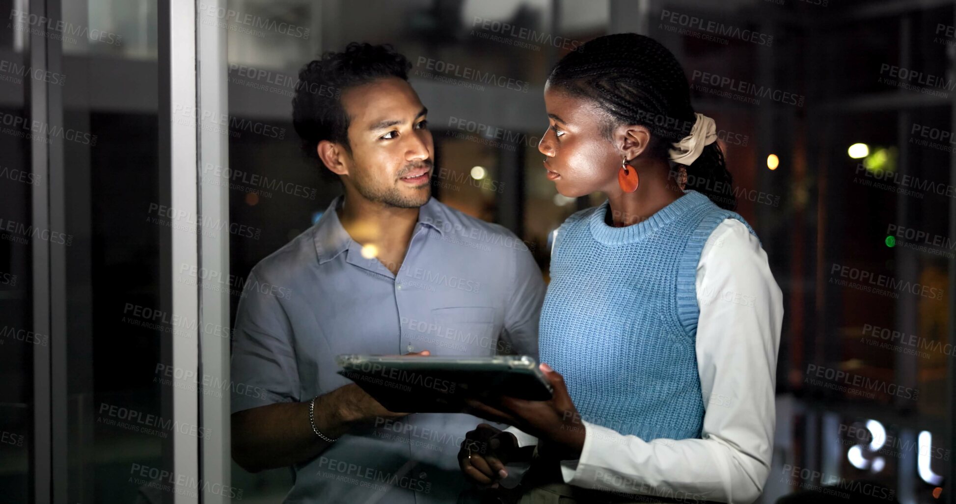 Buy stock photo Night, people and discussion in office with tablet, journalist collaboration and research for story. Late, coworkers and talk in workplace with tech, teamwork and review for online news publication.