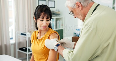 Buy stock photo Vaccine, patient and doctor with plaster in office, medical appointment and flu immunization for health. Wound protection, mature woman and man with illness prevention shot, healthcare and hospital