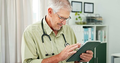 Buy stock photo Man, doctor and reading with tablet in office for research, test results and medical report. Smile, mature person and digital for telehealth, patient information and healthcare record for treatment